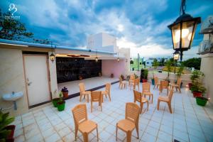 a patio with chairs and tables on a building at PARADISE BANQUET HALL & A/C ROOMS in Madurai