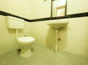 a bathroom with a toilet and a sink at PARADISE BANQUET HALL & A/C ROOMS in Madurai