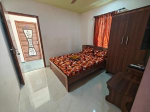 a bedroom with a bed and a window at PARADISE BANQUET HALL & A/C ROOMS in Madurai