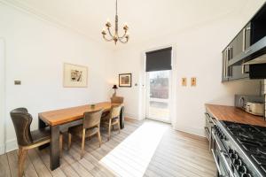 a kitchen with a dining room table and chairs at Desswood Aberdeen City Centre Apartment in Aberdeen