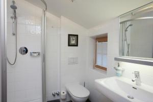 a bathroom with a toilet and a sink and a shower at Chalet Alpinum in Sankt Anton am Arlberg