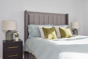 een slaapkamer met een groot bed met gele kussens bij No41 Cowes in Cowes