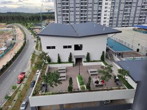 a white building with a swimming pool and a building at İmpiana Homestay near PUTRAJAYA, CYBERJAYA, Musliem Only,WIFI,Netflix in Kampung Dengkil