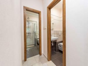 a bathroom with a shower and a toilet and a mirror at Holiday home Kozino/Zadar Riviera 33795 in Kožino