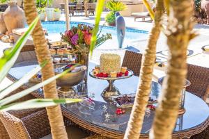 a table with a cake and desserts on a table at Kwantu Guesthouse 1 in Cape Town