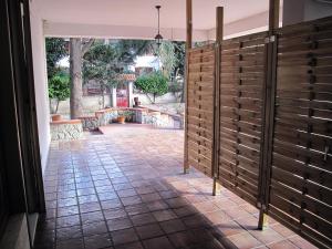 a room with a wooden fence and a patio at la casa di Emilia in Nocera Inferiore