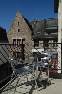 a table and two chairs sitting on a balcony at Appartement au centre-ville Concarneau in Concarneau