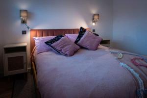 a bedroom with a bed with two pillows on it at Amber Lights Coastal Getaway, Greatstone in Greatstone
