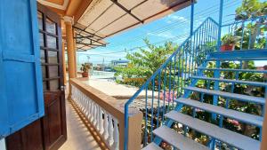 a blue stair case in a house with a blue door at Maidi Homestay Mui Ne in Mui Ne