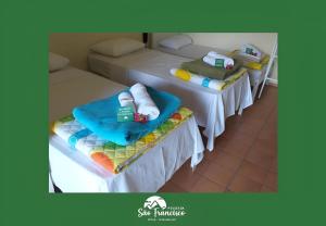 two beds with towels on them in a room at Pousada São Francisco PETAR in Iporanga