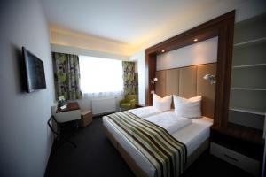 Postel nebo postele na pokoji v ubytování Hotel Alea City