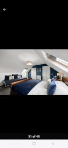 a bedroom with a large bed with a blue blanket at Fort William loft on shore front with amazing views in Caol