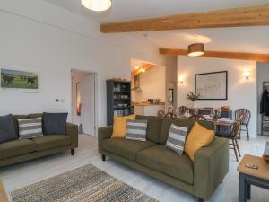 a living room with two couches and a dining room at The Cook House in Devizes