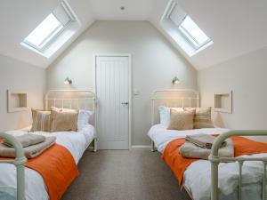 two beds in a attic room with skylights at 4 Bed in Llandudno 80288 in Rhos-on-Sea