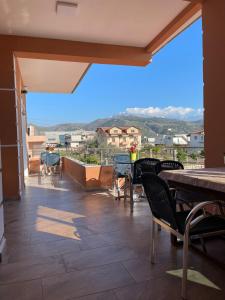 a balcony with tables and chairs and a view at Harmony Villa Berat in Berat