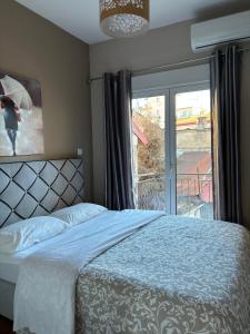 a bedroom with a bed and a window with an umbrella at Old Town Home Ioannina in Ioannina