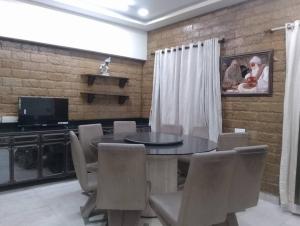 een eetkamer met een tafel en stoelen bij Luxurious 3 bedroom hall in Bandra west in Mumbai
