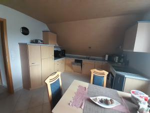 a kitchen with a table and two chairs and a table and a table at Ferienwohnung Stefan Schwiemann in Cadenberge