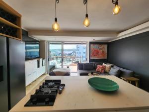a kitchen and living room with a stove and a couch at Quay Five on the Waterfront in Knysna