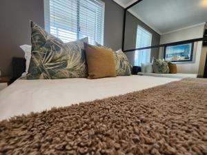a bedroom with a large bed with pillows on it at Quay Five on the Waterfront in Knysna