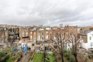 an aerial view of a city with brick buildings at Light-filled Primrose Hill Rooftop Retreat in London