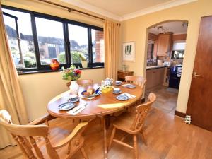 a dining room with a wooden table and chairs at 2 Bed in Winfrith Newburgh DC018 in Winfrith Newburgh