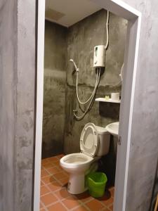 a small bathroom with a toilet and a sink at Cat Bungalow in Ko Lanta