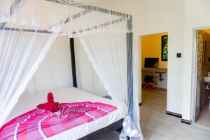 a bedroom with a bed with a canopy at Mountain Relax Inn in Weligama
