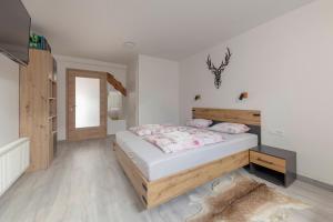 a bedroom with a large bed and a mirror at Apartma Naravni biser in Brezje