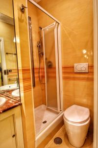 een badkamer met een douche, een toilet en een wastafel bij Large and Charming Apartment in Trastevere by YourHost in Rome