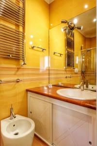 a bathroom with a sink and a mirror at Large and Charming Apartment in Trastevere by YourHost in Rome