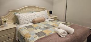 een slaapkamer met een bed met een dekbed en kussens bij Spacious 4 bedroom home in Weir Views near Warrawong Estate in Melton