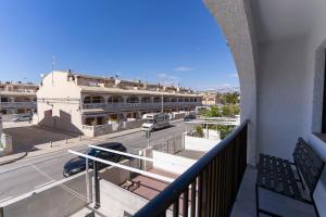 a balcony of a building with a view of a street at rentafive - Gran casa reformada - Terraza in Santa Pola