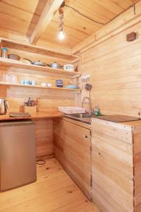a kitchen with wooden walls and wooden counters at Mestia Eco Huts 2 in Mestia