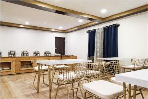 a dining room with tables and chairs at The Crystal Resort in Hundar