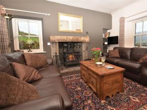 a living room with a couch and a fireplace at 1 Bed in Ballantrae 45713 in Ballantrae