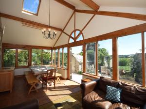 a living room with a table and chairs and windows at 5 Bed in Corfe Castle DC061 in Corfe Castle