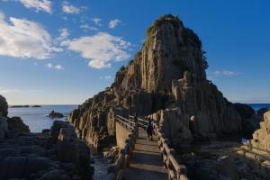 a staircase leading up to a large rock mountain at ワタリグラスハウス in Gamō