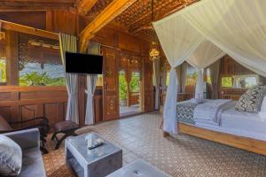 1 dormitorio con 1 cama y TV en una habitación en Billys Ayodya Villa, en Perean