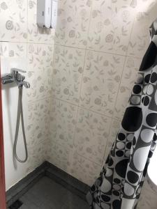 a shower in a bathroom with a shower curtain at Rest Easy Inn in Ulaanbaatar
