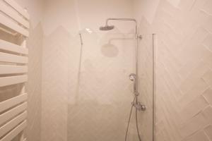 a shower with a glass door in a bathroom at eg42b - Modernista apartamento en el centro de Barcelona in Barcelona