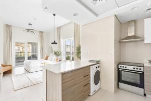 a kitchen and living room with a stove top oven at Silkhaus Sea View studio in Marina Rise Tower in Abu Dhabi