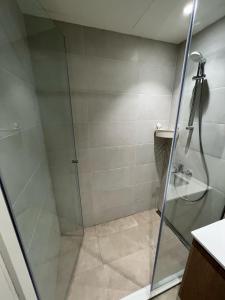 a shower with a glass door in a bathroom at Angel BW Apartments in Sajmište