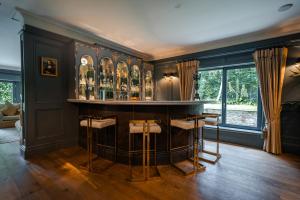 a bar in a room with a bunch of bottles at Luxury Lodge Tinakilly in Wicklow