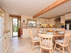 a kitchen with a wooden table and chairs at 3 bed in Cressbrook 57037 in Cressbrook