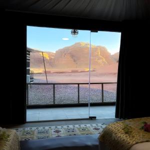 a room with a view of a mountain through a window at WADI Rum STARLIGHT CAMP in Wadi Rum