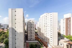 a view of two tall white buildings in a city at BHomy Bela Vista - Ap bem localizado ALFM4 in Sao Paulo