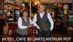 a man and a woman standing in a bar at Hotel,cafe,biljart POT in Groenlo