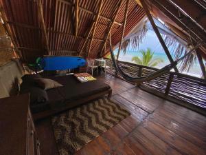 a bed in a room with a view of the ocean at Frente al Mar in Dibulla