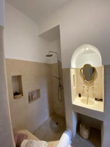 a bathroom with a sink and a mirror at Riad Djebel in Marrakech
